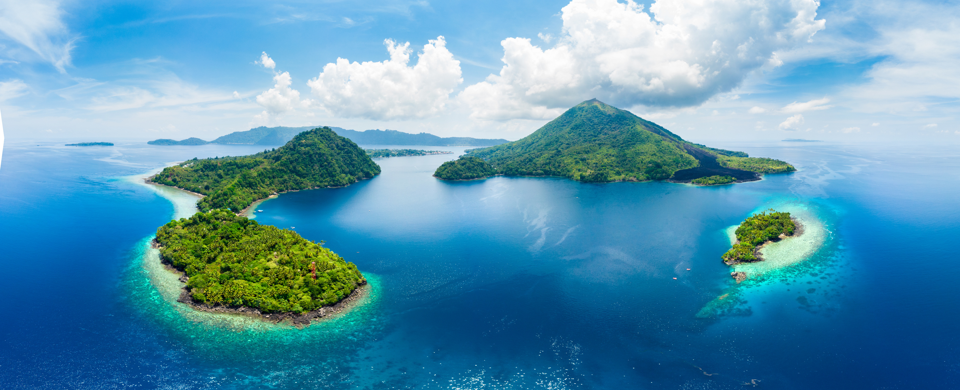 Aerial view Banda Islands Moluccas archipelago Indonesia, Pulau Gunung Api, lava flows, coral reef white sand beach. Top travel tourist destination, best diving snorkeling.